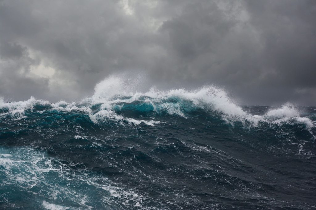 Stormy ocean waves under dark cloudy sky