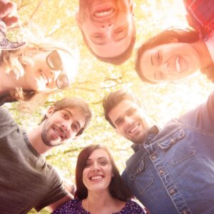 Smiling group of friends looking down at camera