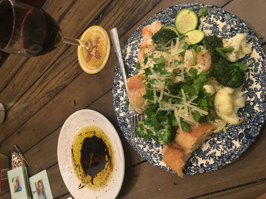 shrimp, cauliflower, broccoli, zucchini, and pasta in creamy Alfredo sauce