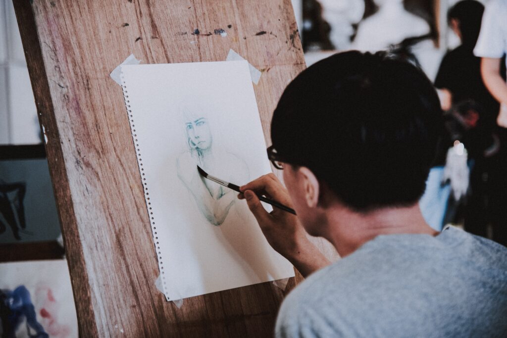 Person sketching a human figure