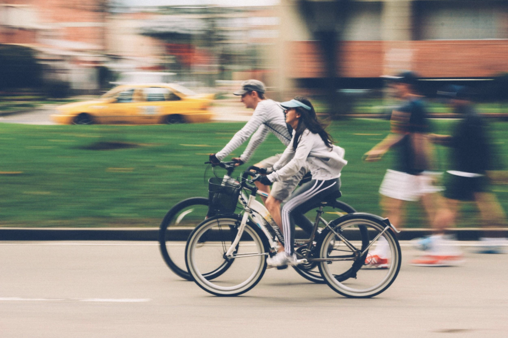 Two people riding their bikes on a path