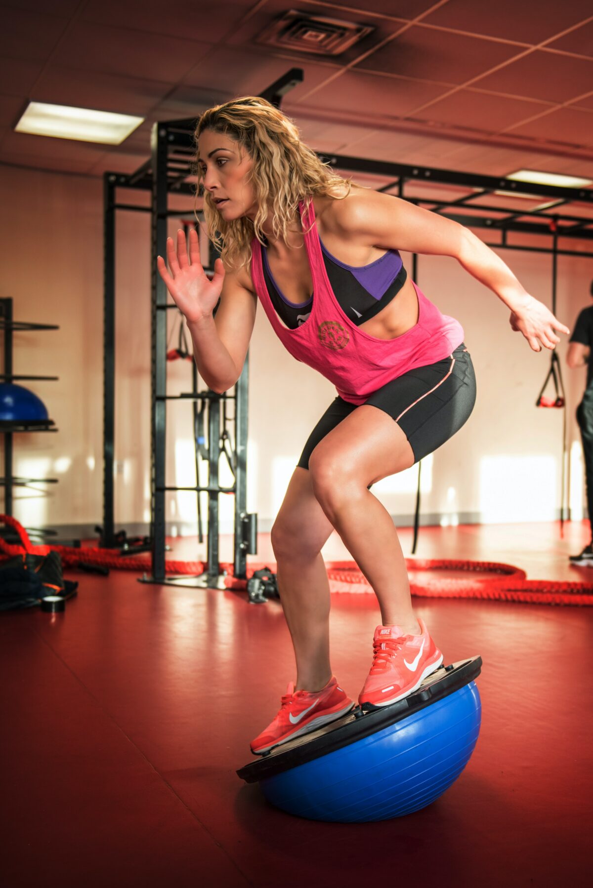 Woman doing functional fitness in gym on BOSU