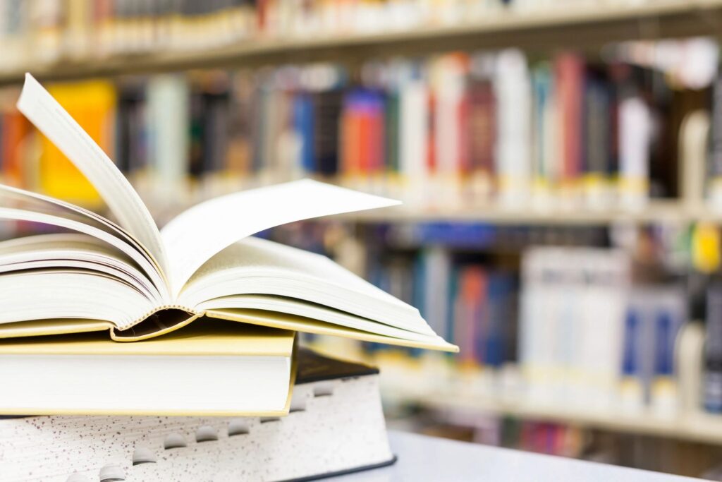Open book on stack in library