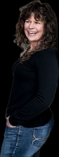 Smiling woman with curly hair in black