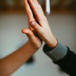 hands of two people giving each other a high five