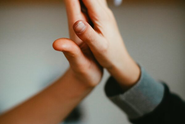 hands of two people giving each other a high five