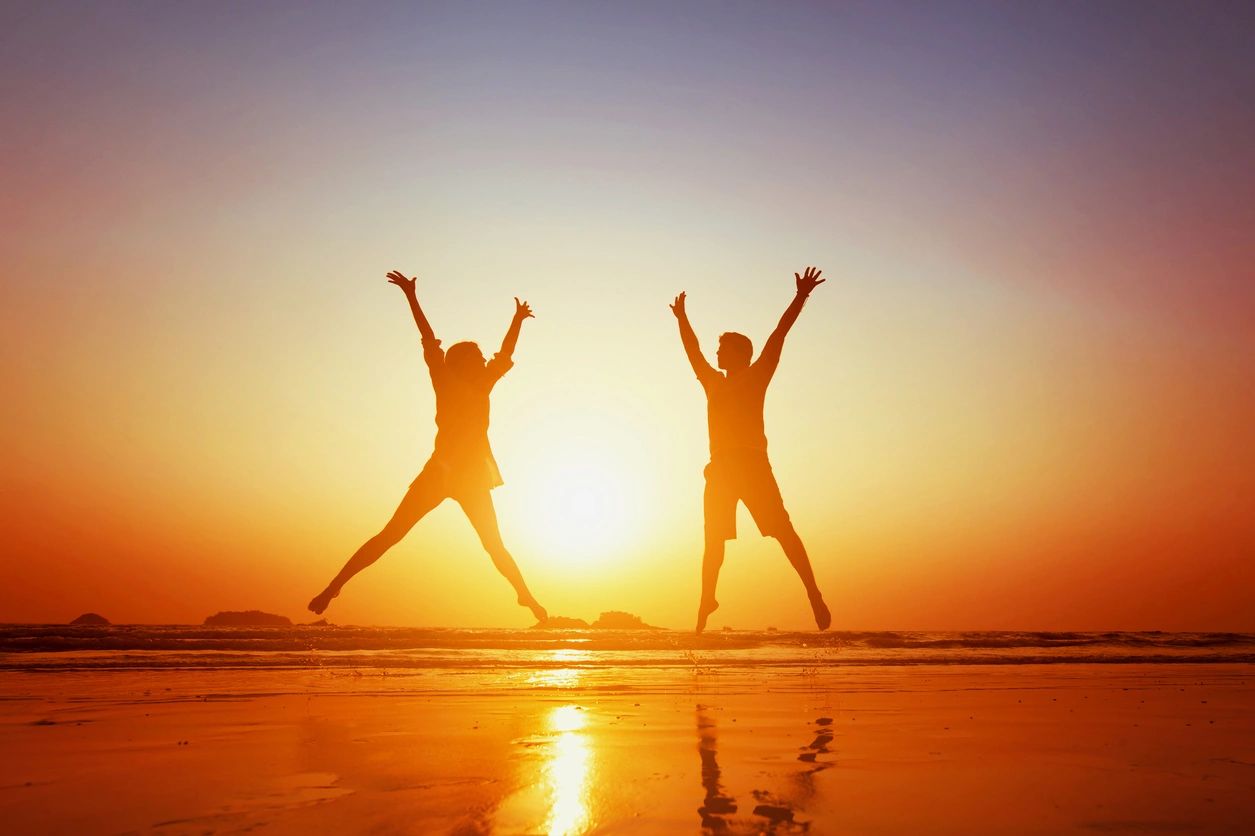 qtq80-j0JFGH two people jumping on beach in sunset